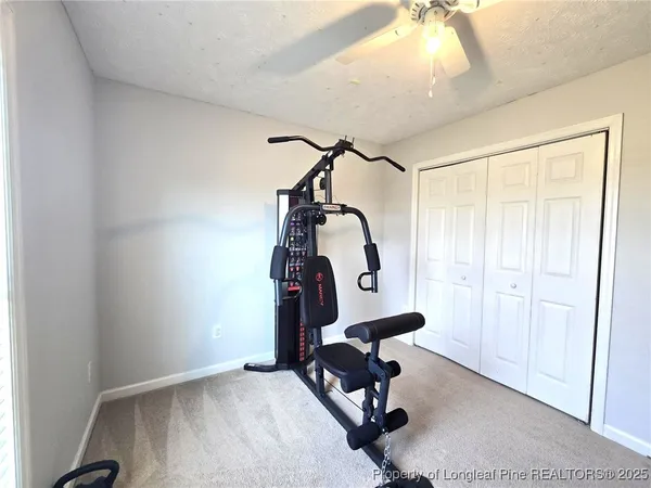 a room with gym equipment and windows