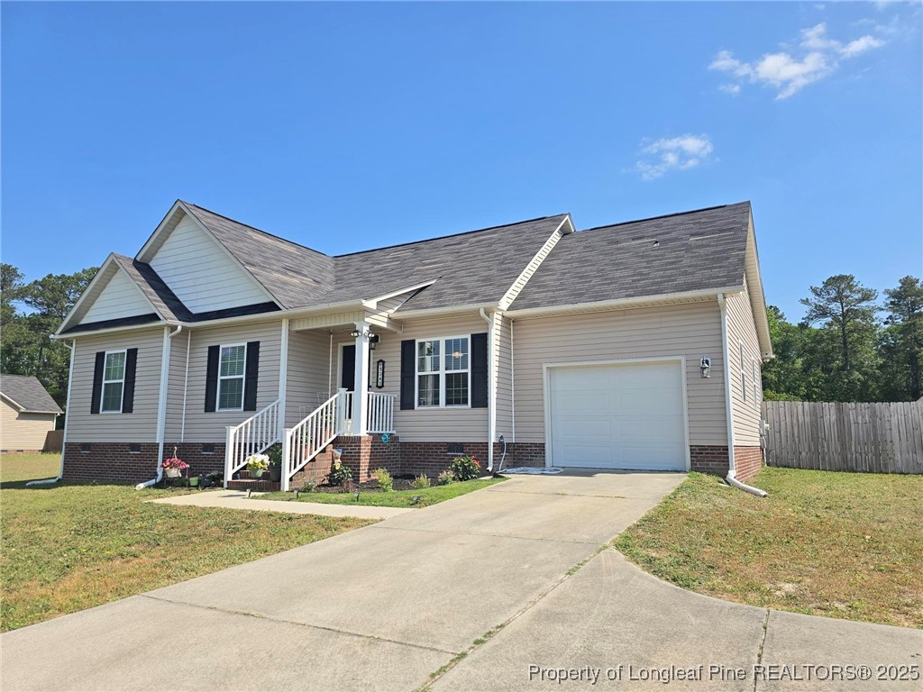 5345 Pittman Grove Church Road Raeford, NC 28376 - Photo 4 of 45 a front view of a house with a yard and garage