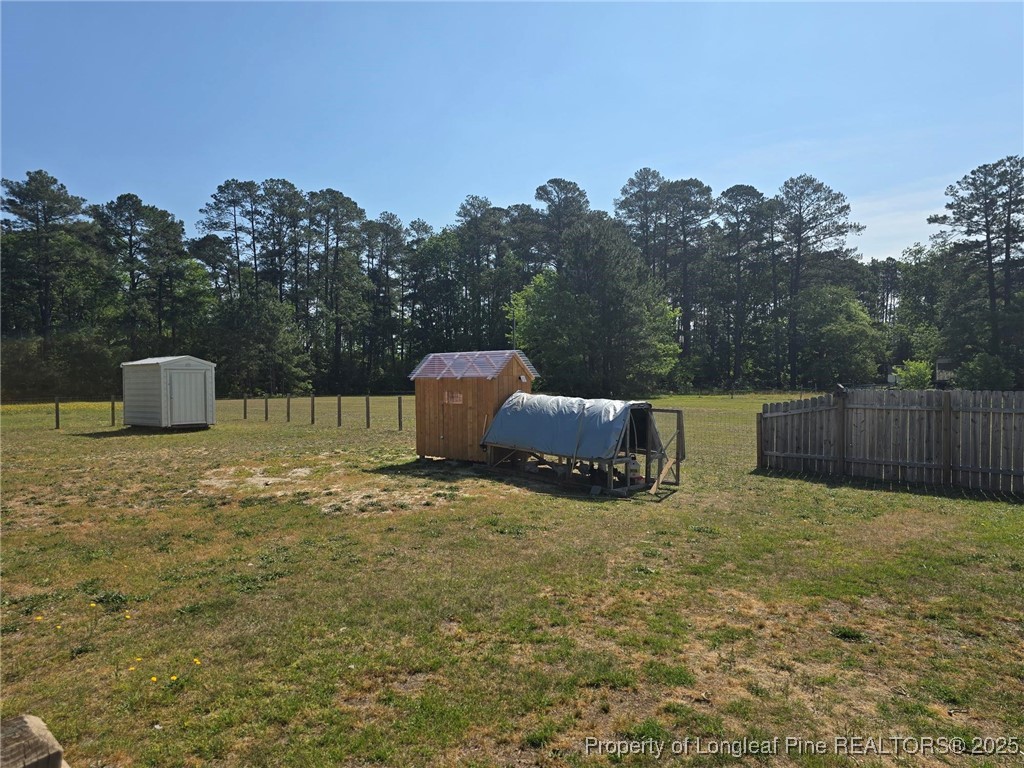 5345 Pittman Grove Church Road Raeford, NC 28376 - Photo 43 of 45 a backyard of a house with table and sofas