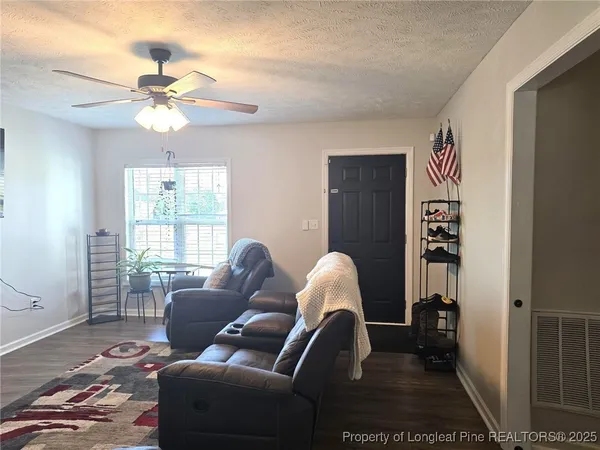a living room with furniture and a window