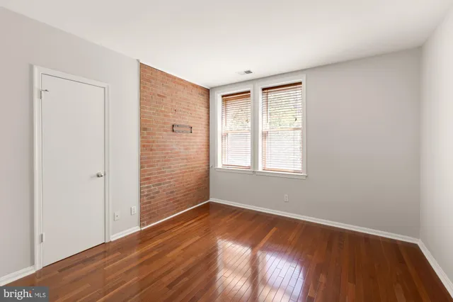 a view of a livingroom with wooden floor and window