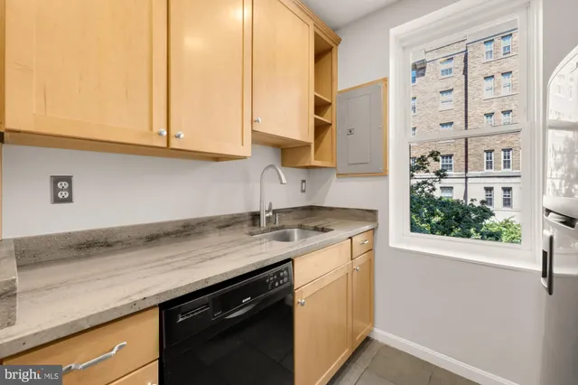 a kitchen with stainless steel appliances granite countertop a sink a stove and a microwave