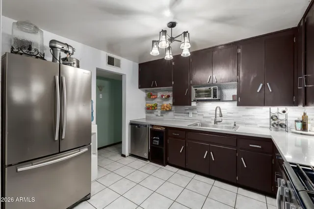 a kitchen with stainless steel appliances granite countertop a refrigerator and a sink