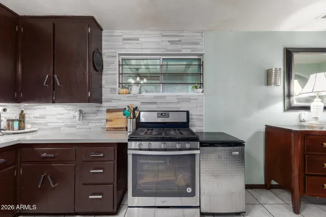 a kitchen with granite countertop a stove and a sink