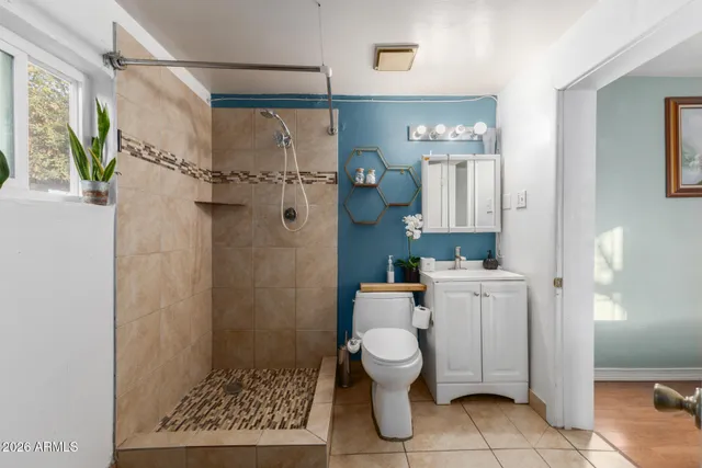 a bathroom with a toilet and a shower