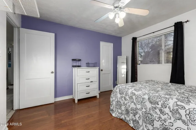 a bedroom with a large bed and a dresser