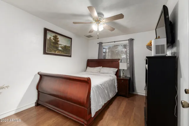 a bedroom with a bed and a flat screen tv