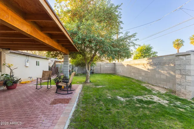 a view of a house with backyard porch and sitting area