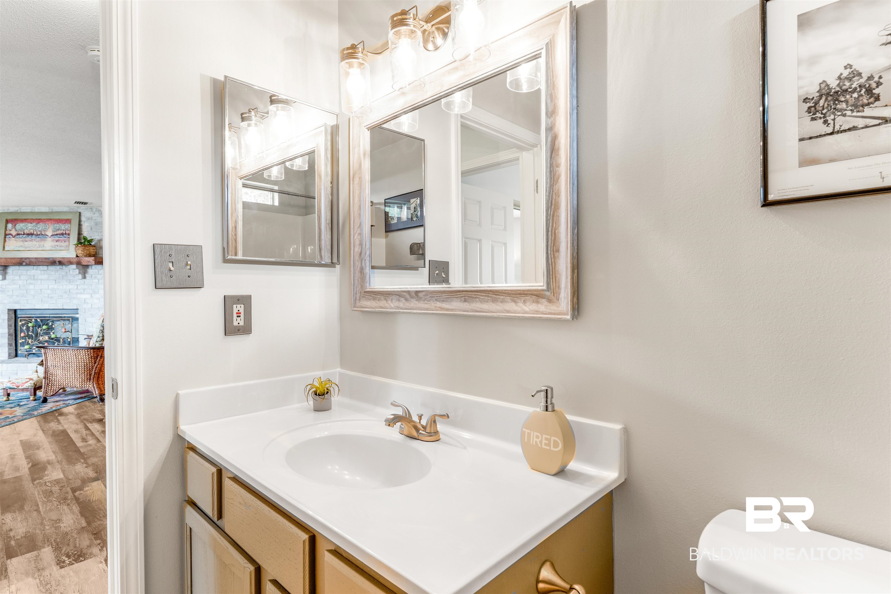 518 Ariel Avenue Foley, AL 36535 - Photo 29 of 47 Bathroom featuring a fireplace, vanity, toilet, and hardwood / wood-style flooring