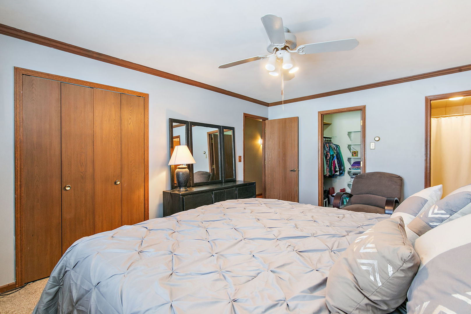 183 Brookside Drive Elgin, IL 60123 - Photo 16 of 46 a bed room with a bed and a chandelier
