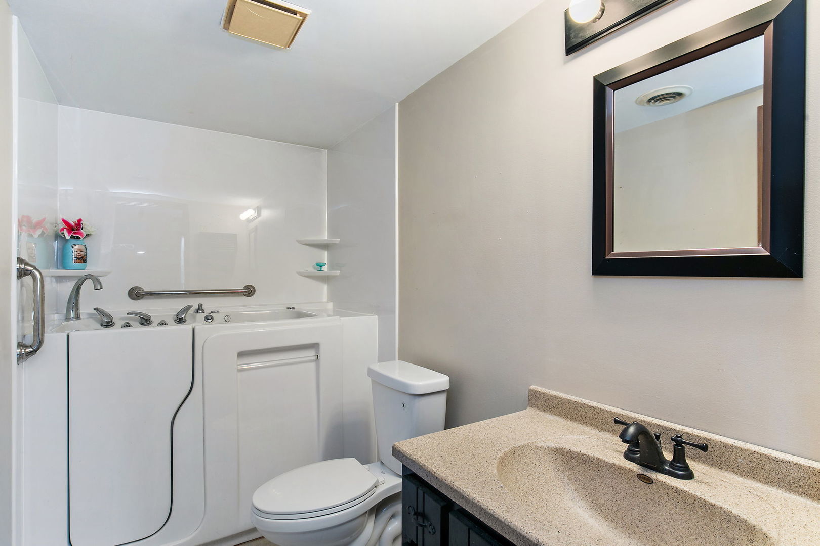 183 Brookside Drive Elgin, IL 60123 - Photo 29 of 46 a bathroom with a granite countertop toilet sink and mirror