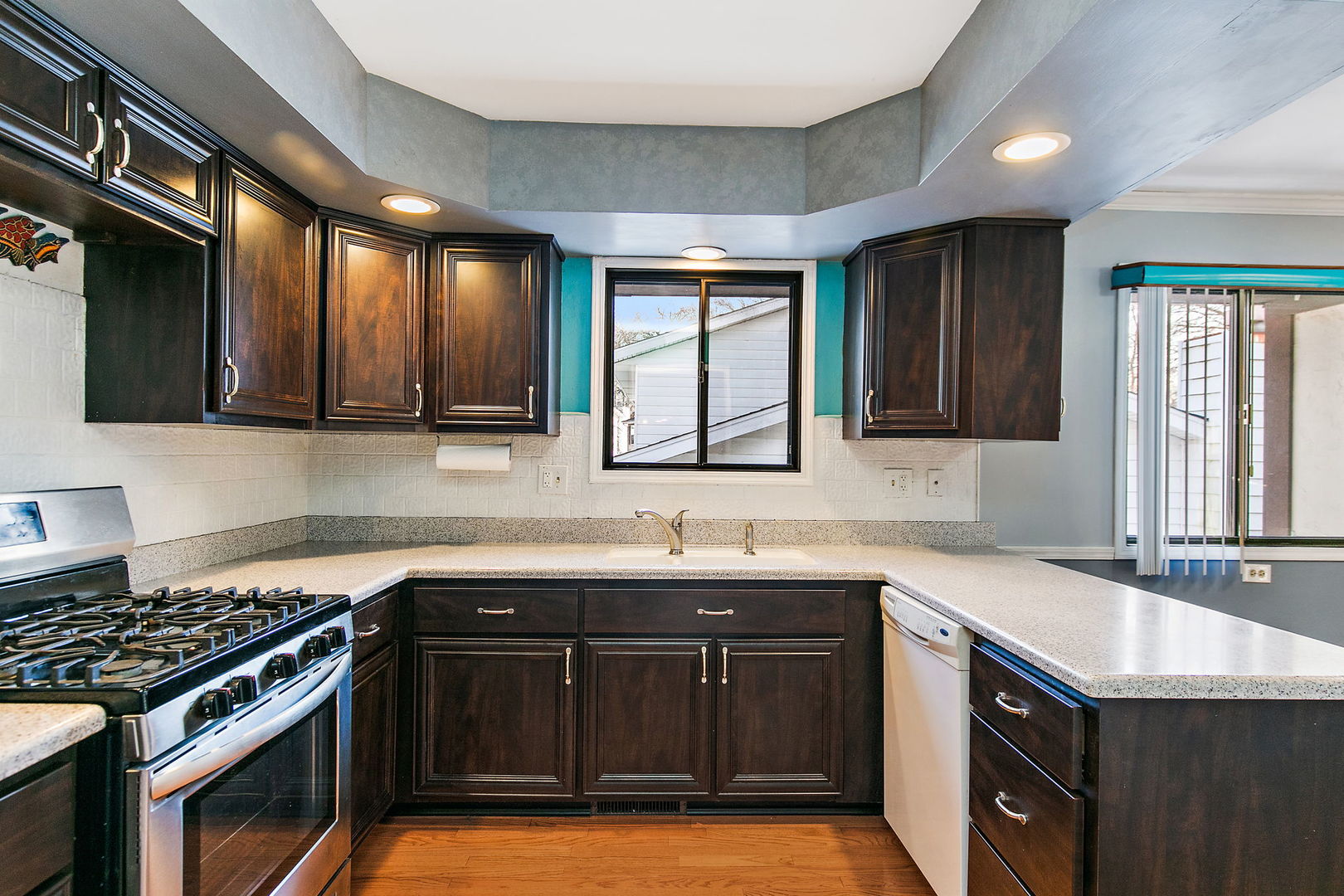 183 Brookside Drive Elgin, IL 60123 - Photo 10 of 46 a kitchen with granite countertop a sink stove and cabinets