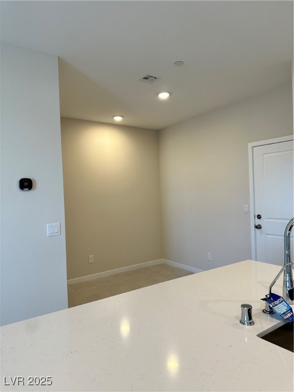 Kitchen with recessed lighting and light stone counters