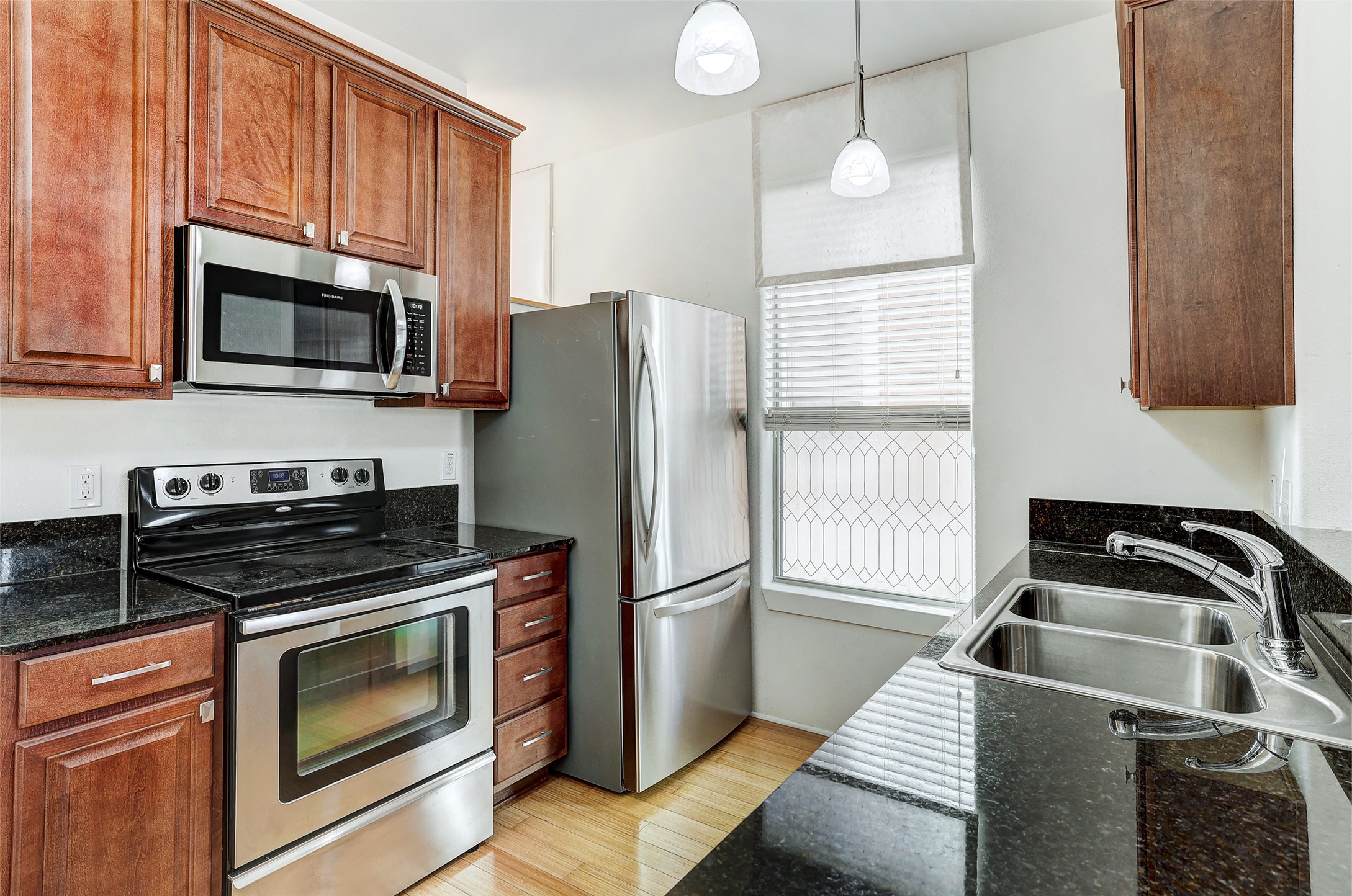 13420 Lyndhurst Street, Unit 208 Austin, TX 78717 - Photo 11 of 40 a kitchen with a refrigerator stove and microwave