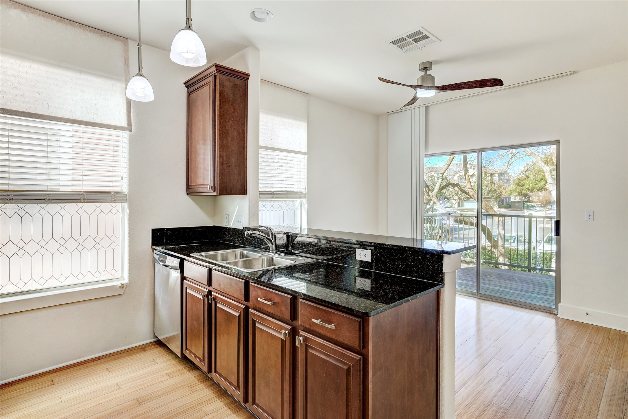 13420 Lyndhurst Street, Unit 208 Austin, TX 78717 - Photo 13 of 40 a kitchen that has a sink and a wooden floor
