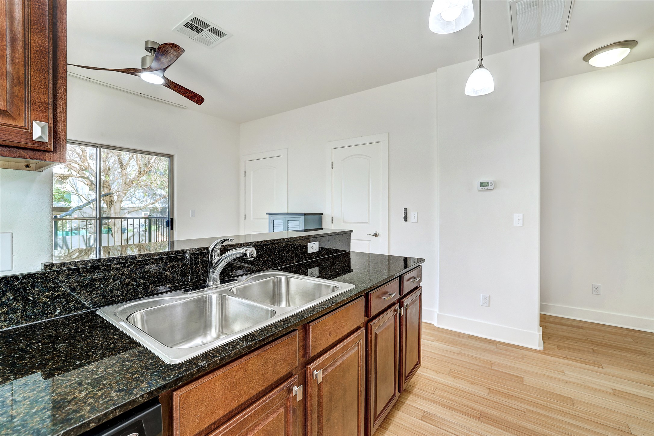 13420 Lyndhurst Street, Unit 208 Austin, TX 78717 - Photo 14 of 40 a kitchen with granite countertop a sink and a stove