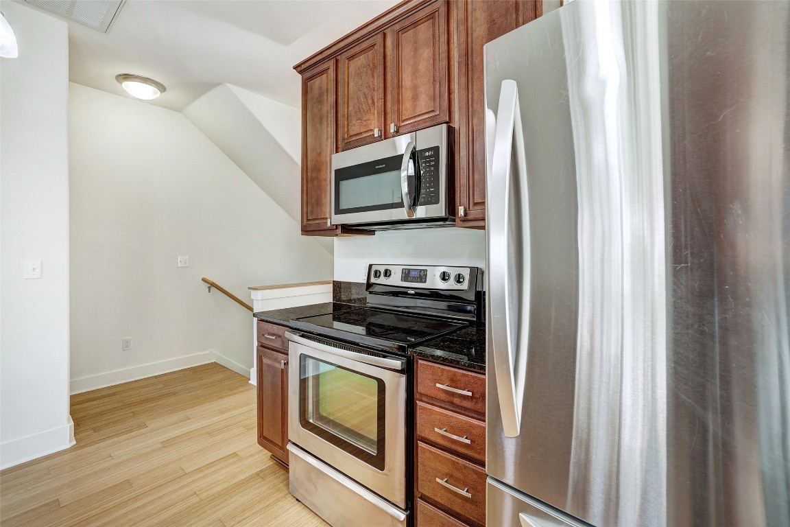 13420 Lyndhurst Street, Unit 208 Austin, TX 78717 - Photo 15 of 40 a kitchen with stainless steel appliances granite countertop a stove microwave and refrigerator