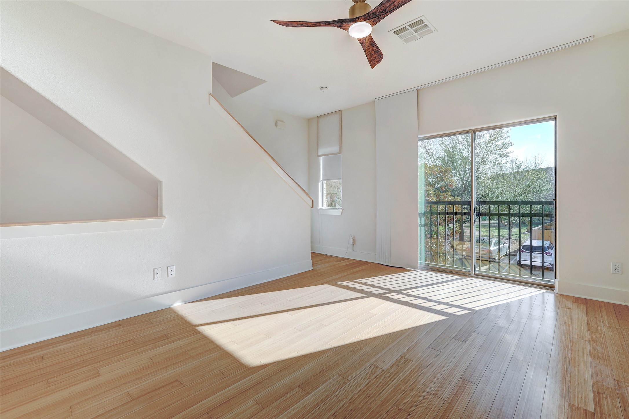 13420 Lyndhurst Street, Unit 208 Austin, TX 78717 - Photo 19 of 40 a view of an empty room with wooden floor and a window