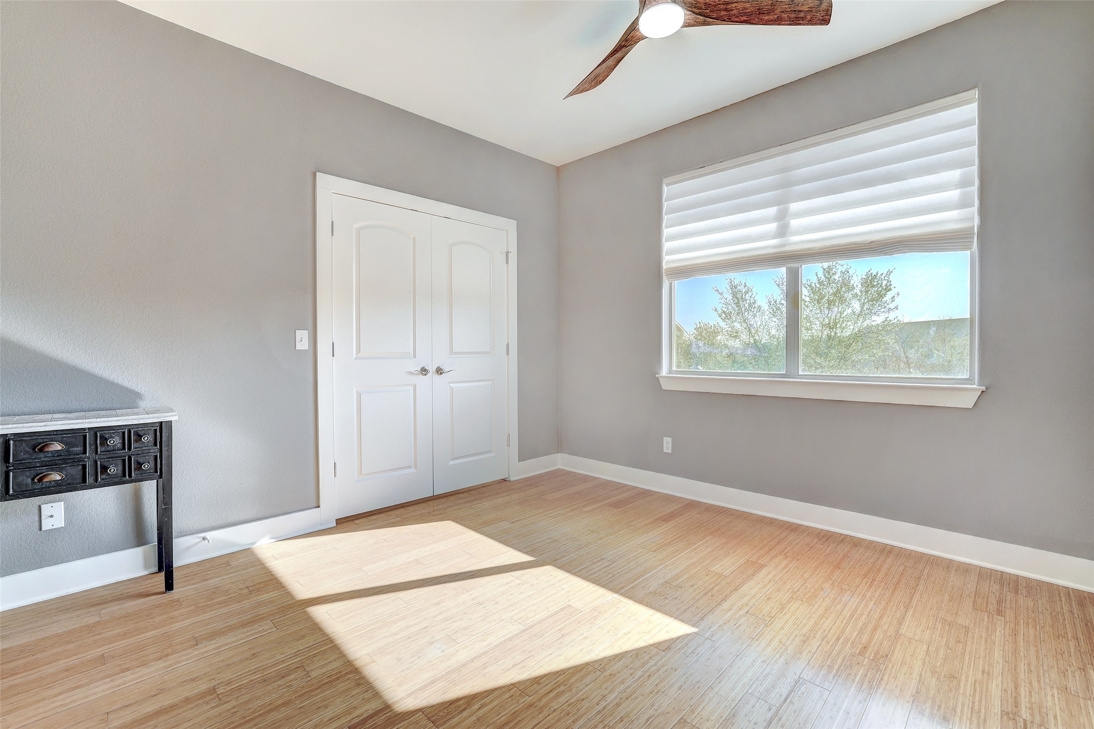13420 Lyndhurst Street, Unit 208 Austin, TX 78717 - Photo 23 of 40 a view of an empty room with wooden floor and a window