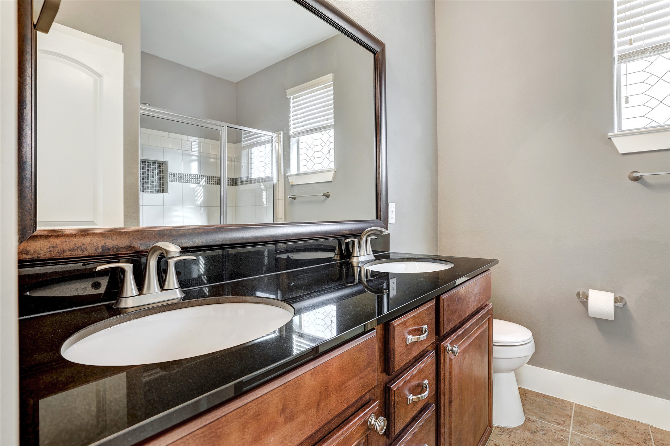 13420 Lyndhurst Street, Unit 208 Austin, TX 78717 - Photo 27 of 40 a bathroom with a granite countertop sink and a mirror