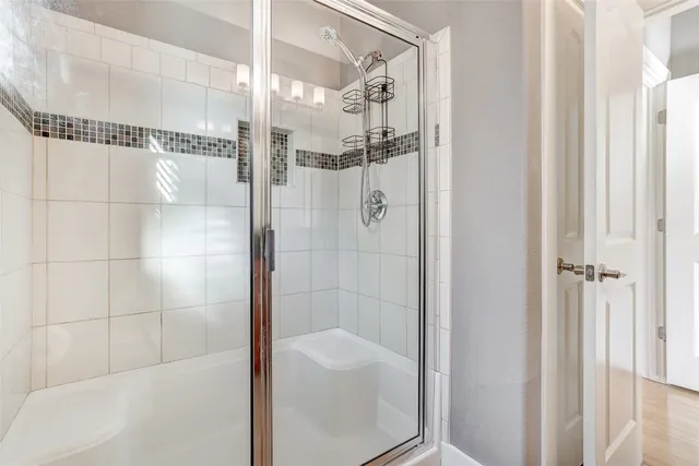a bathroom with a glass shower door