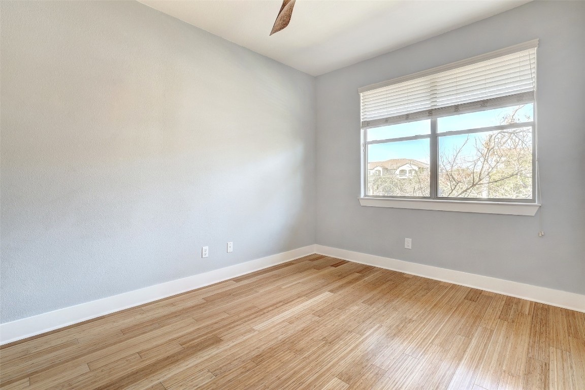 13420 Lyndhurst Street, Unit 208 Austin, TX 78717 - Photo 30 of 40 an empty room with wooden floor and windows