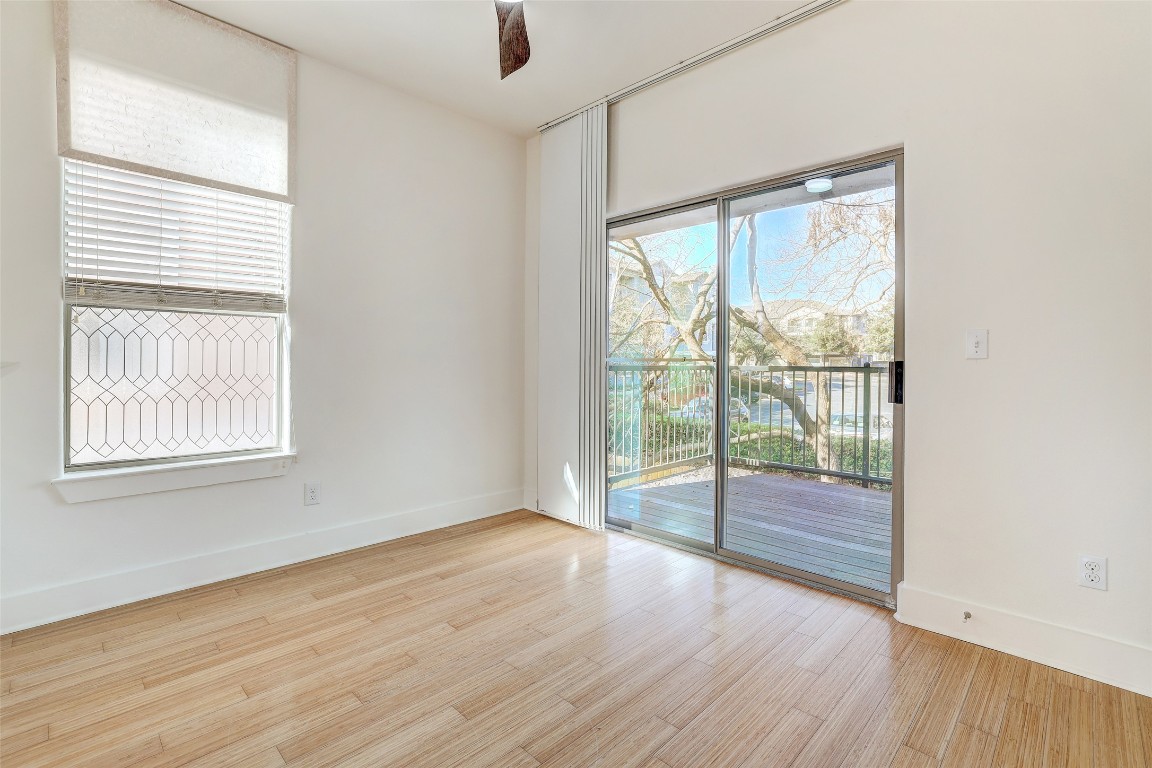 13420 Lyndhurst Street, Unit 208 Austin, TX 78717 - Photo 3 of 40 an empty room with wooden floor and windows