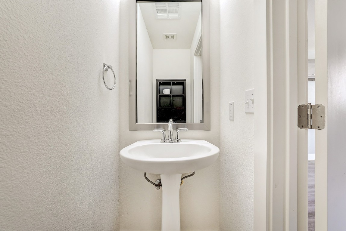 13420 Lyndhurst Street, Unit 208 Austin, TX 78717 - Photo 36 of 40 a bathroom with a sink and a mirror