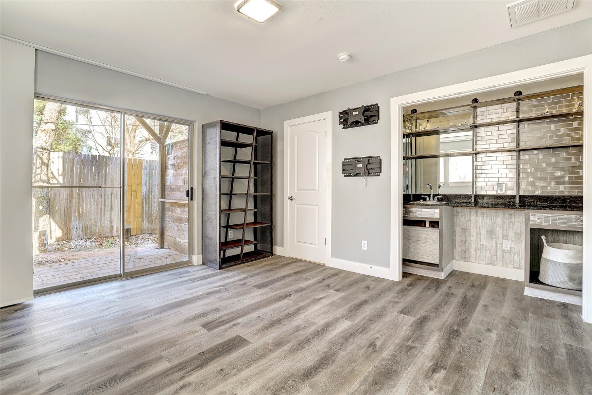 13420 Lyndhurst Street, Unit 208 Austin, TX 78717 - Photo 37 of 40 a view of an empty room with a window and wooden floor