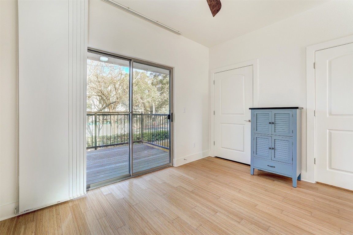 13420 Lyndhurst Street, Unit 208 Austin, TX 78717 - Photo 7 of 40 an empty room with wooden floor and sliding door