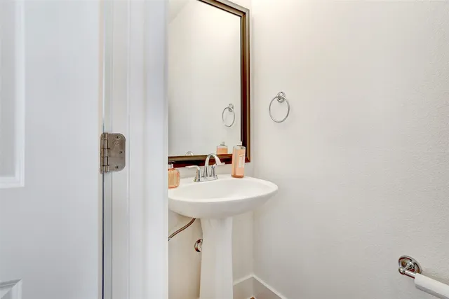 a bathroom with a sink a mirror and shower
