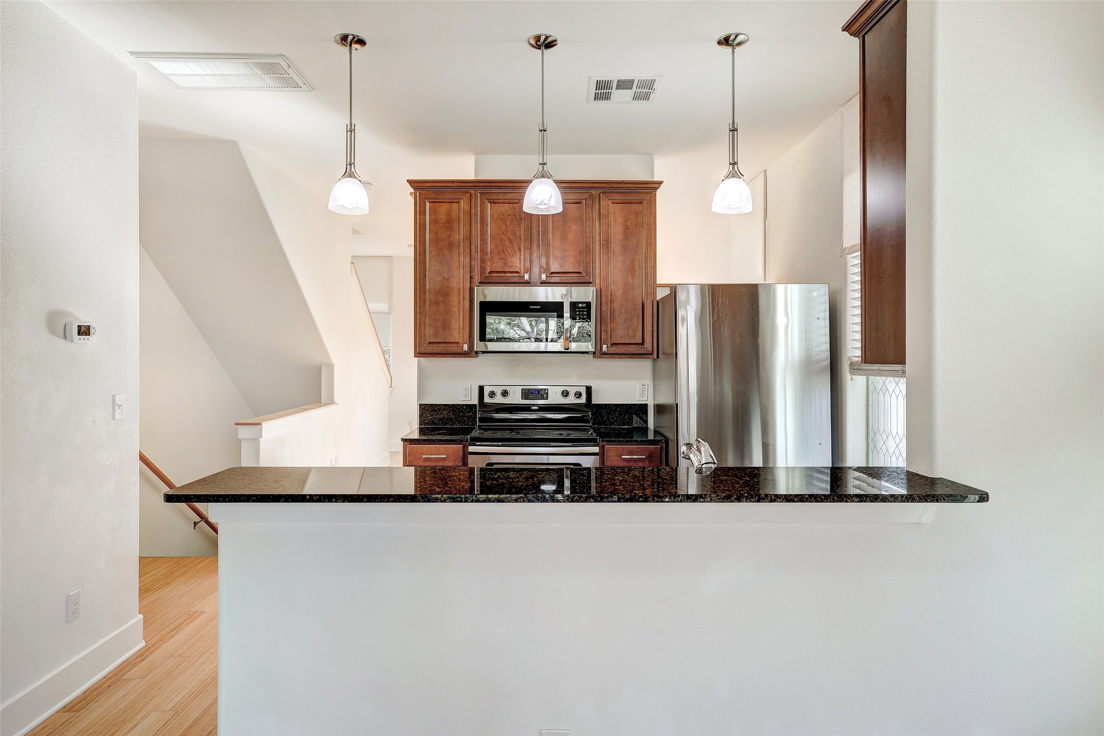 13420 Lyndhurst Street, Unit 208 Austin, TX 78717 - Photo 9 of 40 a kitchen with stainless steel appliances a refrigerator a stove a sink and a chandelier