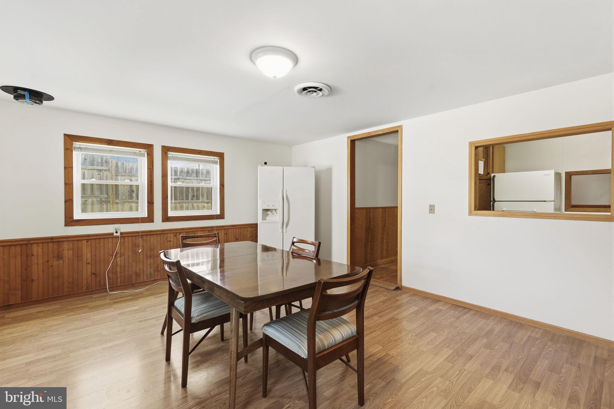 2411 Poplar Road Baltimore, MD 21221 - Photo 19 of 36 a view of a dining room with furniture and wooden floor