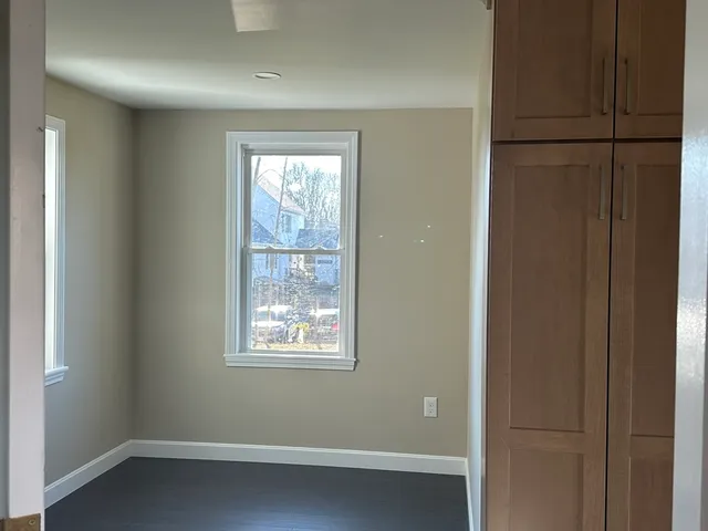a view of a small space with windows and closet