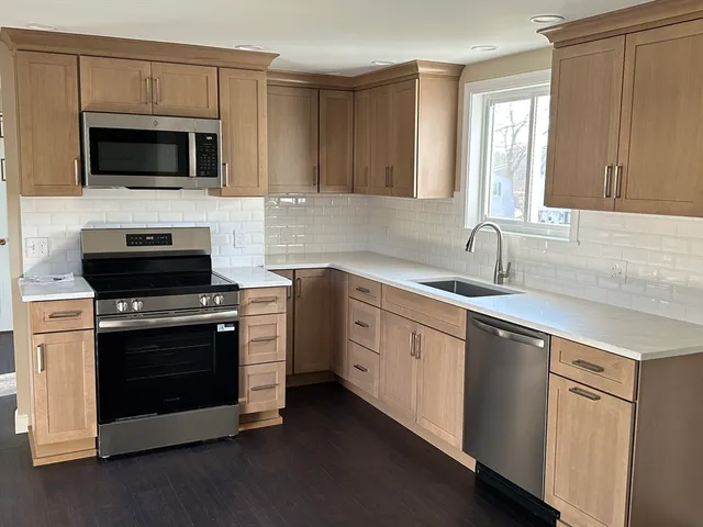 a kitchen with a sink stove and microwave