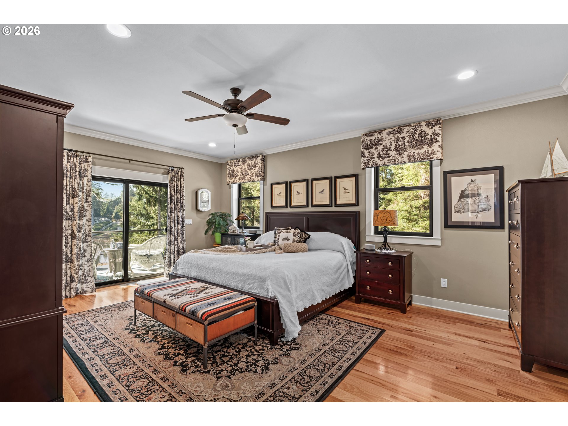83489 Jensen Lane Florence, OR 97439 - Photo 14 of 48 a spacious bedroom with a bed a dresser and a window