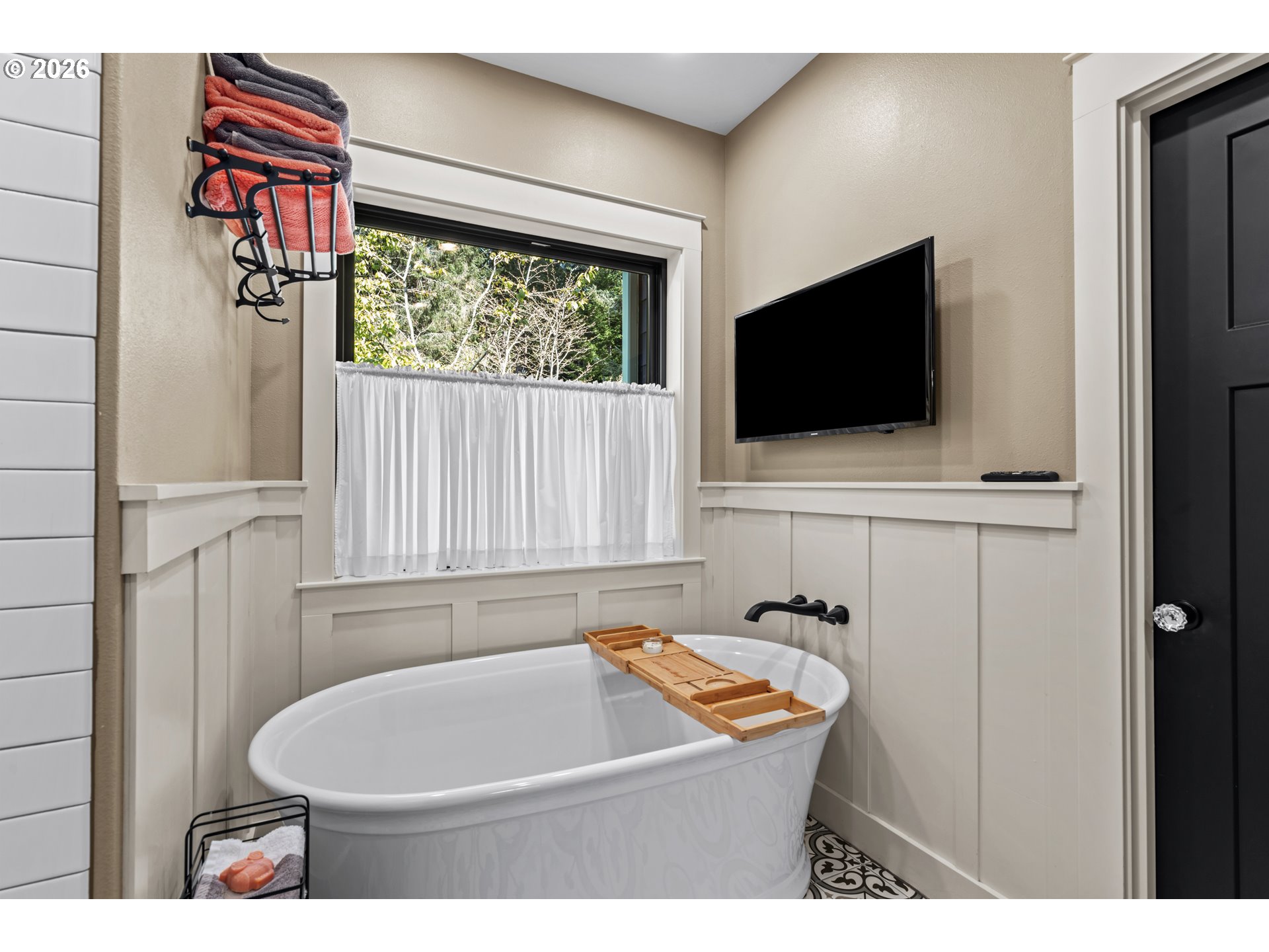 83489 Jensen Lane Florence, OR 97439 - Photo 20 of 48 a bathroom with a sink a bathtub and a flat screen tv