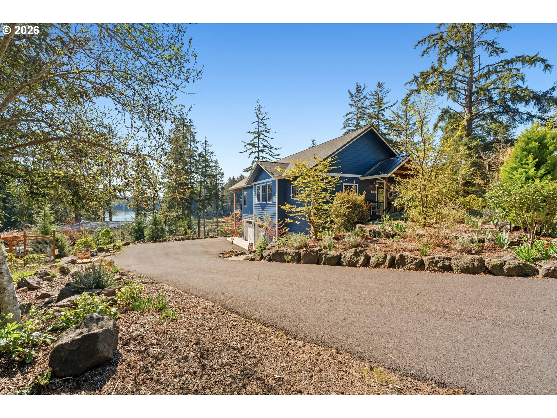 83489 Jensen Lane Florence, OR 97439 - Photo 2 of 48 a front view of a house with a yard and garage