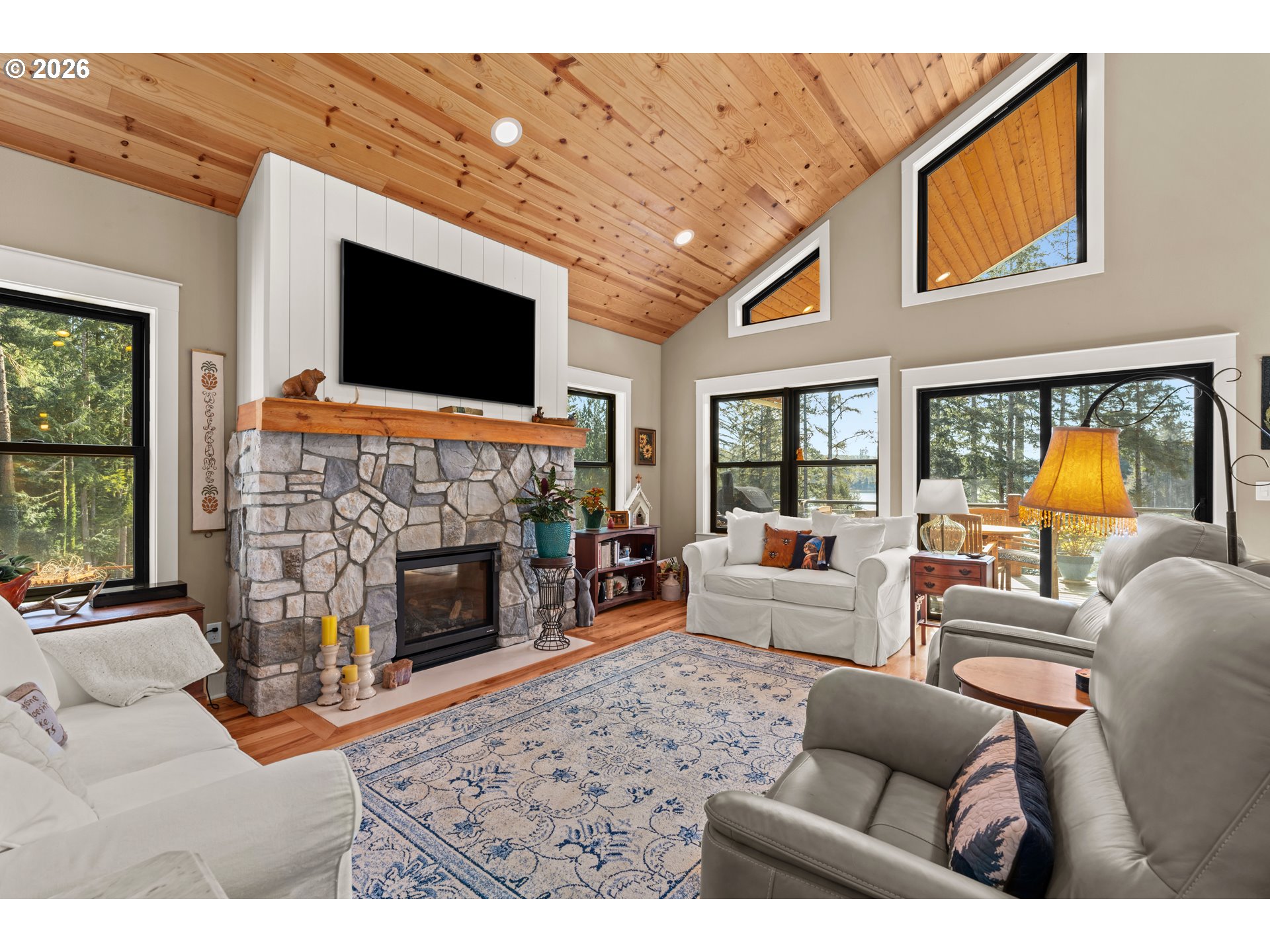 83489 Jensen Lane Florence, OR 97439 - Photo 8 of 48 a living room with furniture a flat screen tv and a fireplace