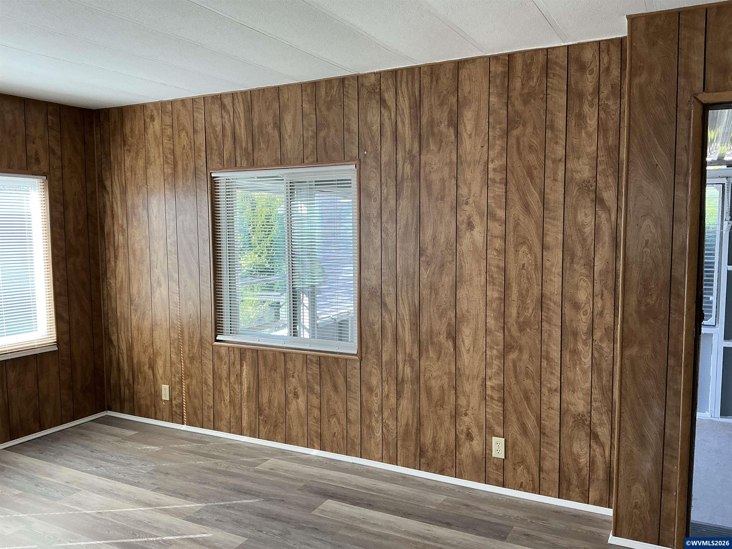 5422 Portland Road Northeast, Unit 67 Salem, OR 97305 - Photo 43 of 45 a view of an empty room with wooden floor