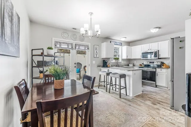 a kitchen with refrigerator a stove and cabinets