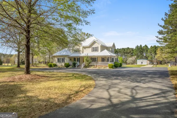a aerial view of a house with swimming pool and sitting area