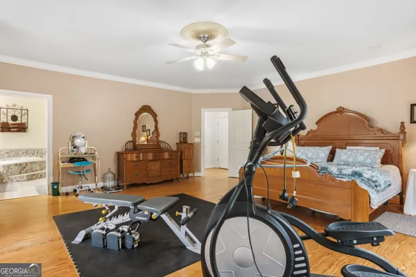 an empty room with a window and ceiling fan