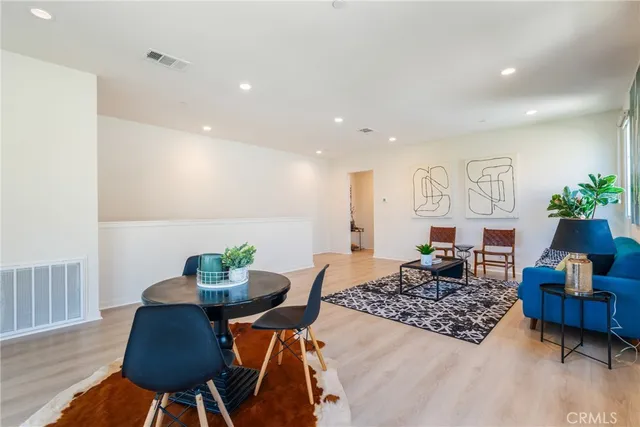 a living room with furniture rug and wooden floor