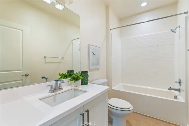 a bathroom with a sink toilet tub and shower