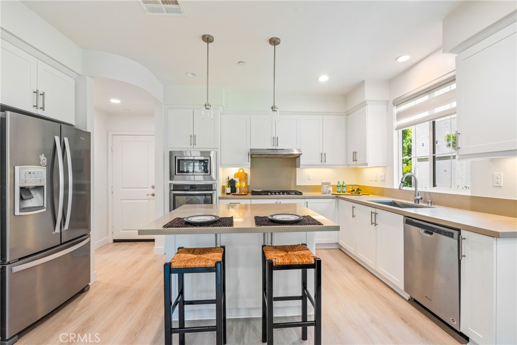 747 Beacon Irvine, CA 92618 - Photo 8 of 28 a kitchen with stainless steel appliances granite countertop a stove a sink and a refrigerator