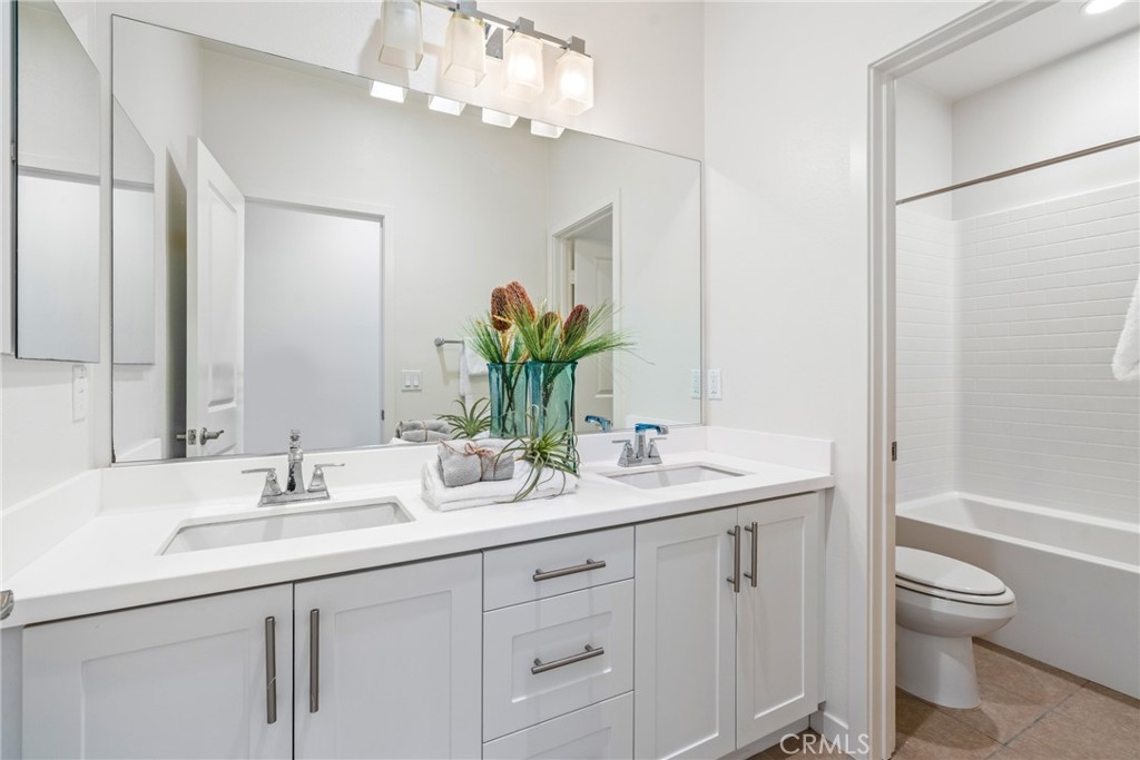 747 Beacon Irvine, CA 92618 - Photo 10 of 28 a bathroom with a sink a toilet and a mirror