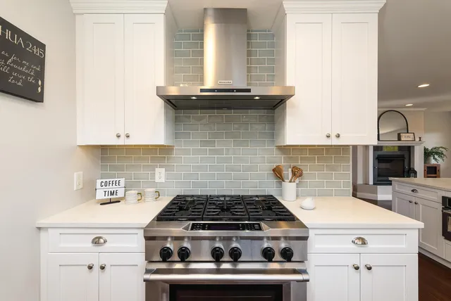 a living room with furniture a flat screen tv and a large window