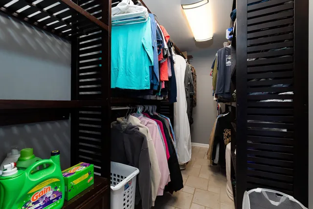 a bedroom with a bed a table and painting