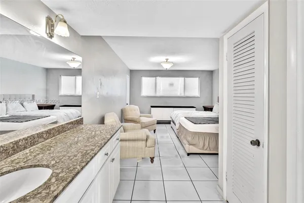 a bedroom with a bed and a couch